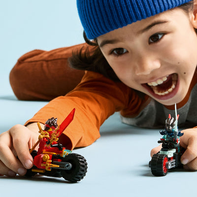 Gara di velocità sulla moto di Kai fotografia bambino che gioca con le moto del set lego